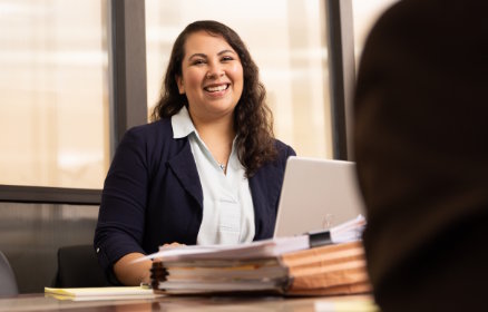 Woman at laptop helping someone