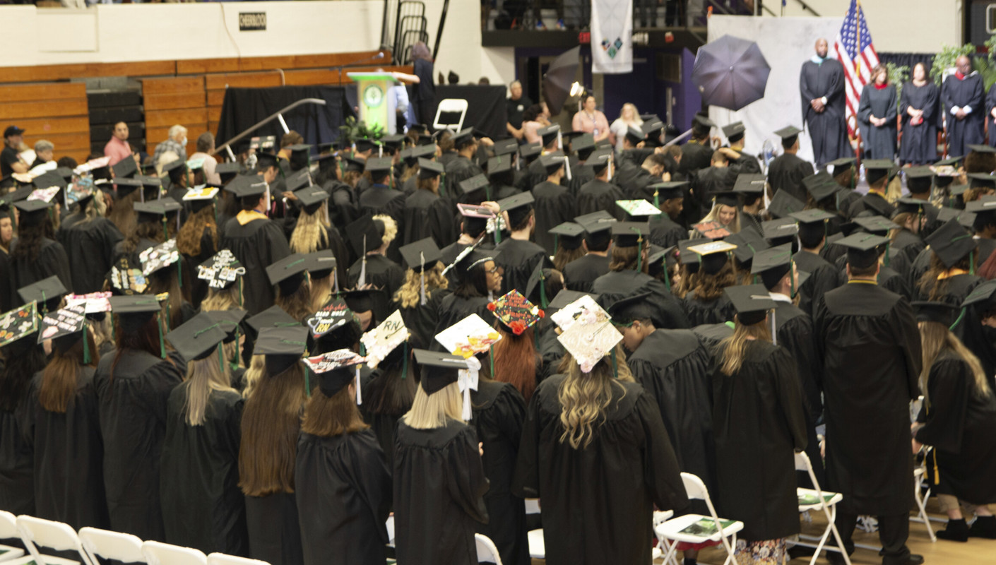The graduates standing during commencement