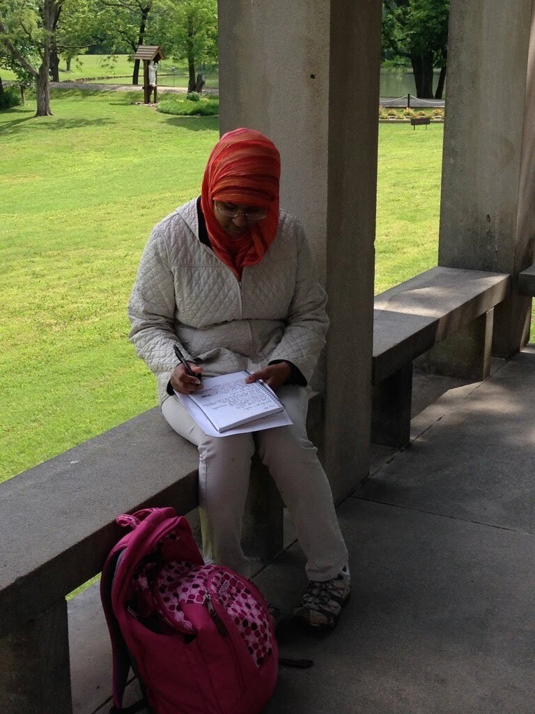 A student sits and writes.