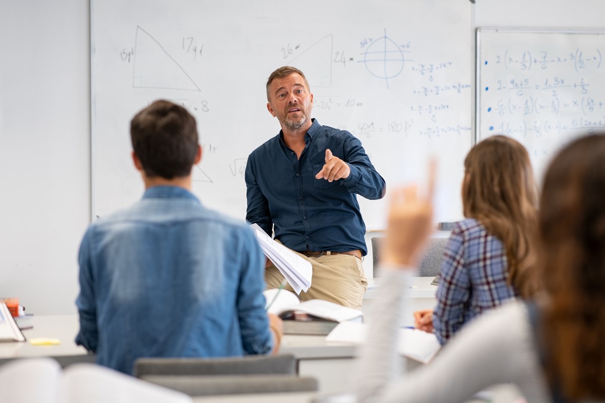 Teacher instructing high school math class.