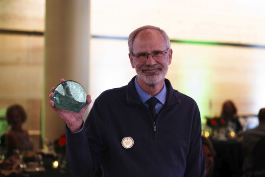Joe Jackson showing his 2026 Alumni of the Year Award.