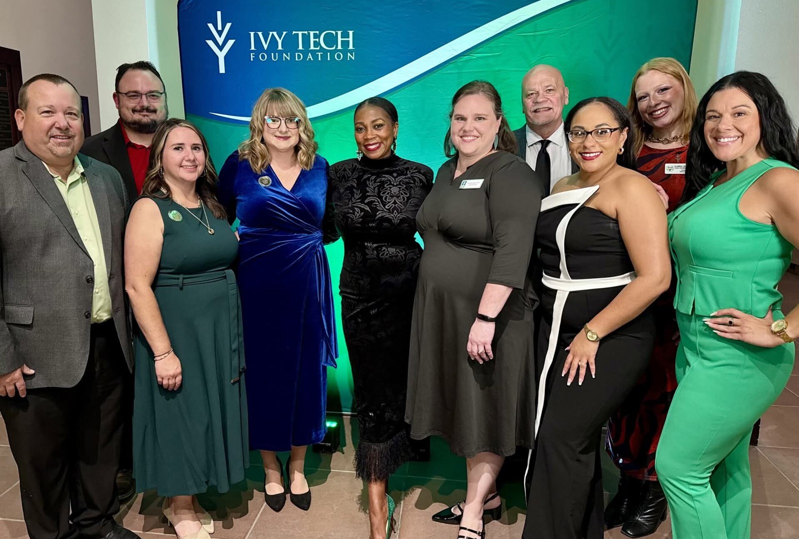 Group photo of Ivy Tech Muncie leadership, staff, and award honorees posing in front of an Ivy Tech Foundation backdrop during the Distinguished Alumni and Benefactor of the Year awards program.