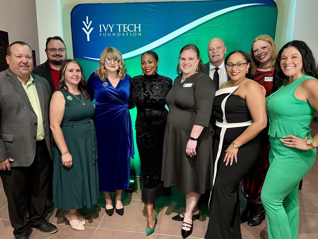Group photo of Ivy Tech Muncie leadership, staff, and award honorees posing in front of an Ivy Tech Foundation backdrop during the Distinguished Alumni and Benefactor of the Year awards program.