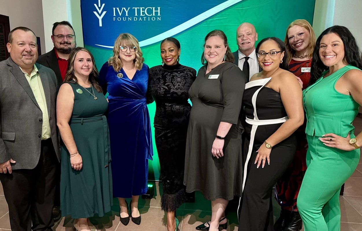 Group photo of Ivy Tech Muncie leadership, staff, and award honorees posing in front of an Ivy Tech Foundation backdrop during the Distinguished Alumni and Benefactor of the Year awards program.